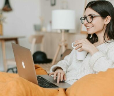 woman having coffee while using laptop