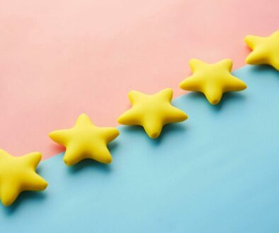 five yellow stars on blue and pink background